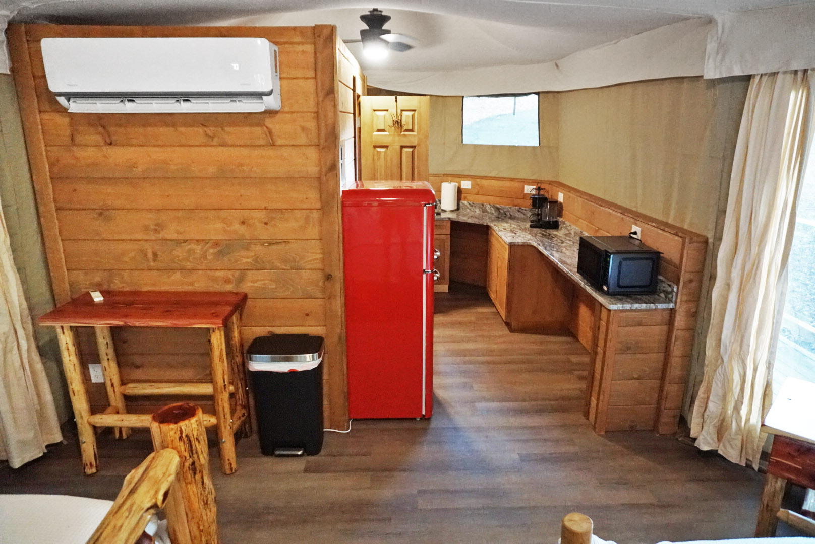 Kitchenette Retreat: Enjoy a vibrant red fridge and rustic charm for your culinary adventures!