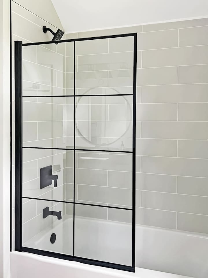 Bathroom with full shower and bathtub off of the main bedroom.