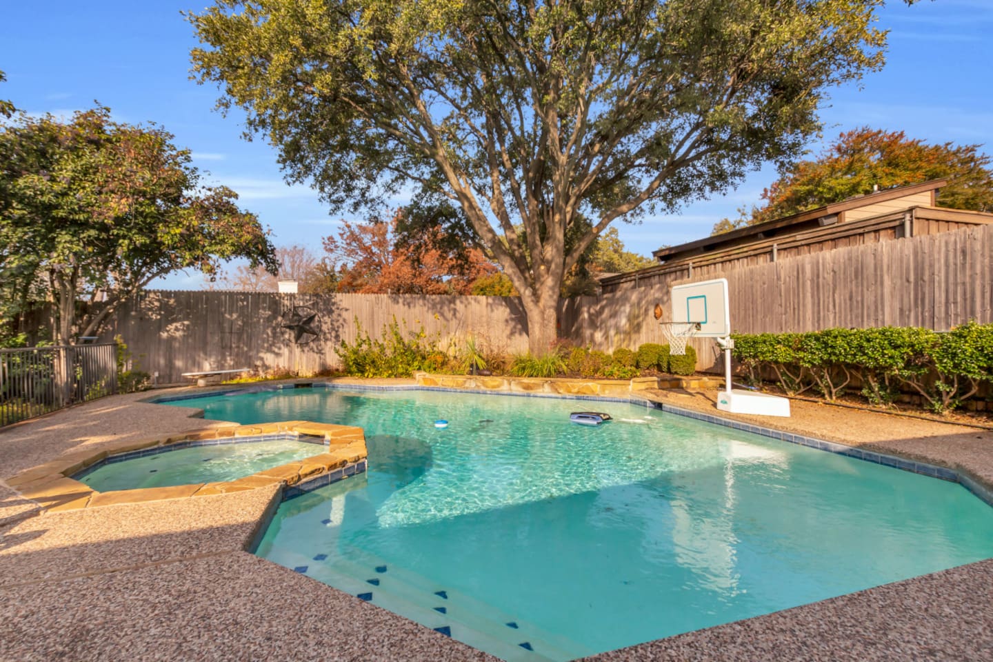 Additional view of the pool and expansive backyard, featuring a spacious, manicured grassy area perfect for kids to play, relax, and enjoy outdoor activities.