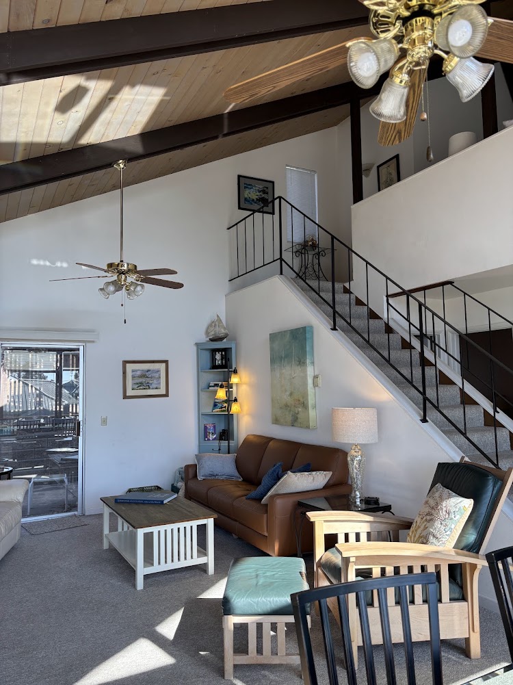 Living area, slider access to back patio. Stairs to loft bedroom.