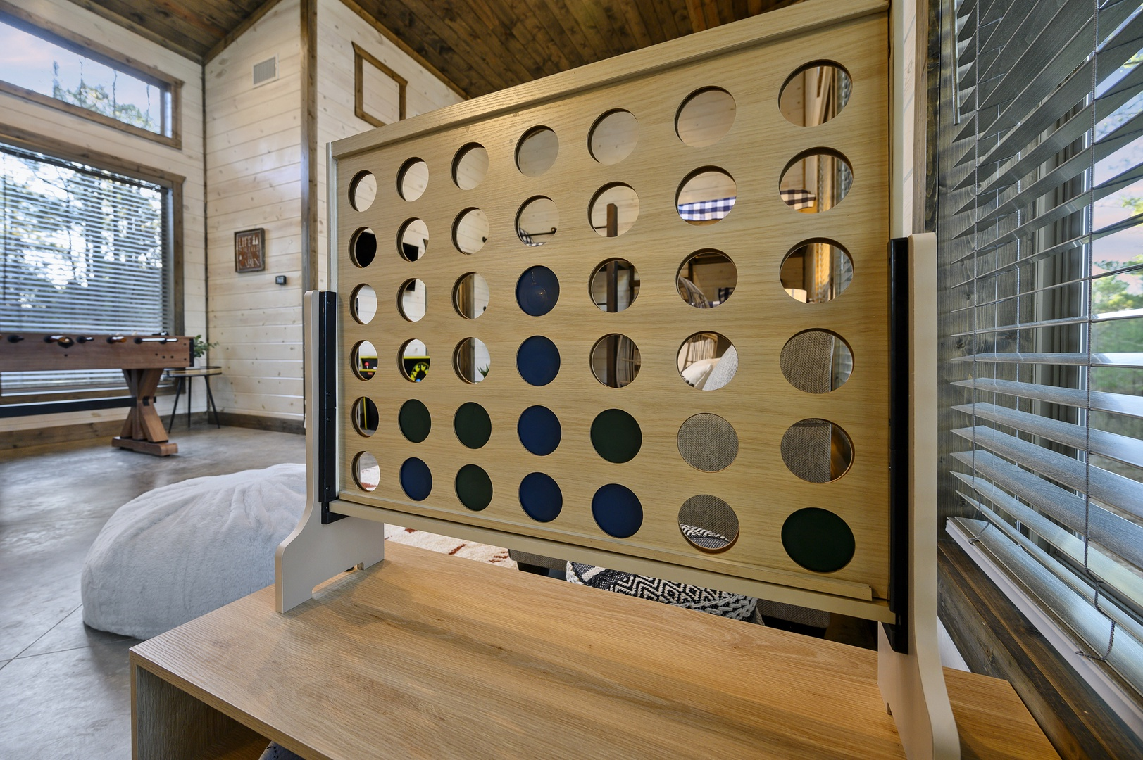 Classic fun meets cozy cabin living — gather for a round of Connect Four and let laughter fill the room.