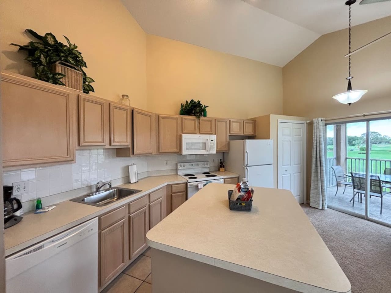 Fully equipped kitchen with plenty of cabinet space, full-size appliances, breakfast bar, and an open layout.