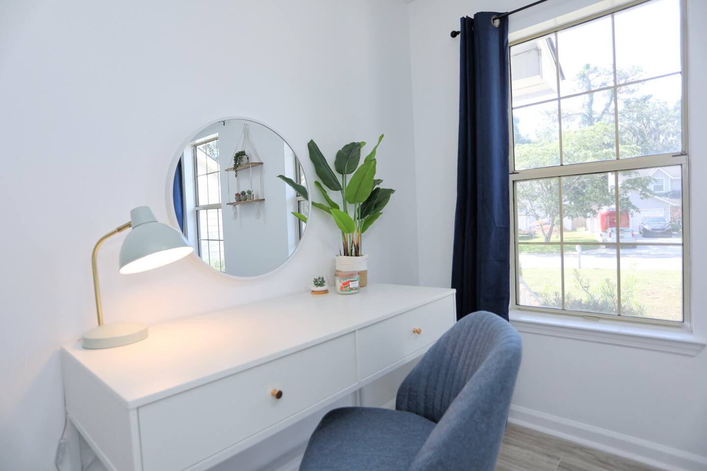 A cozy workspace awaits with a desk, chair, and lamp, perfect for catching up on emails or planning your Savannah adventures.
