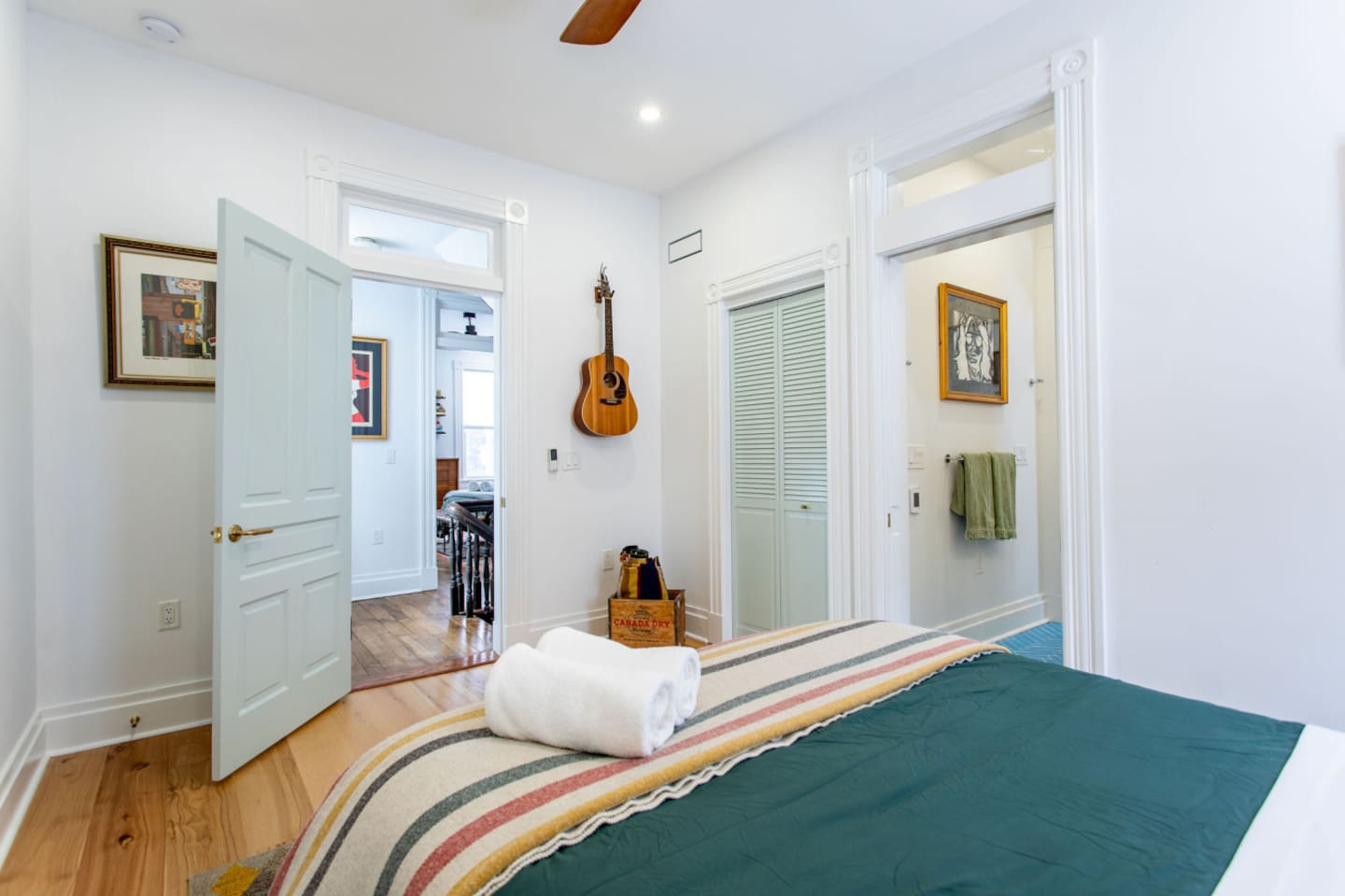 A view from the bed showcasing easy access to both the bathroom and stairs, offering a practical layout that connects the sleeping area to other parts of the home with a seamless flow.