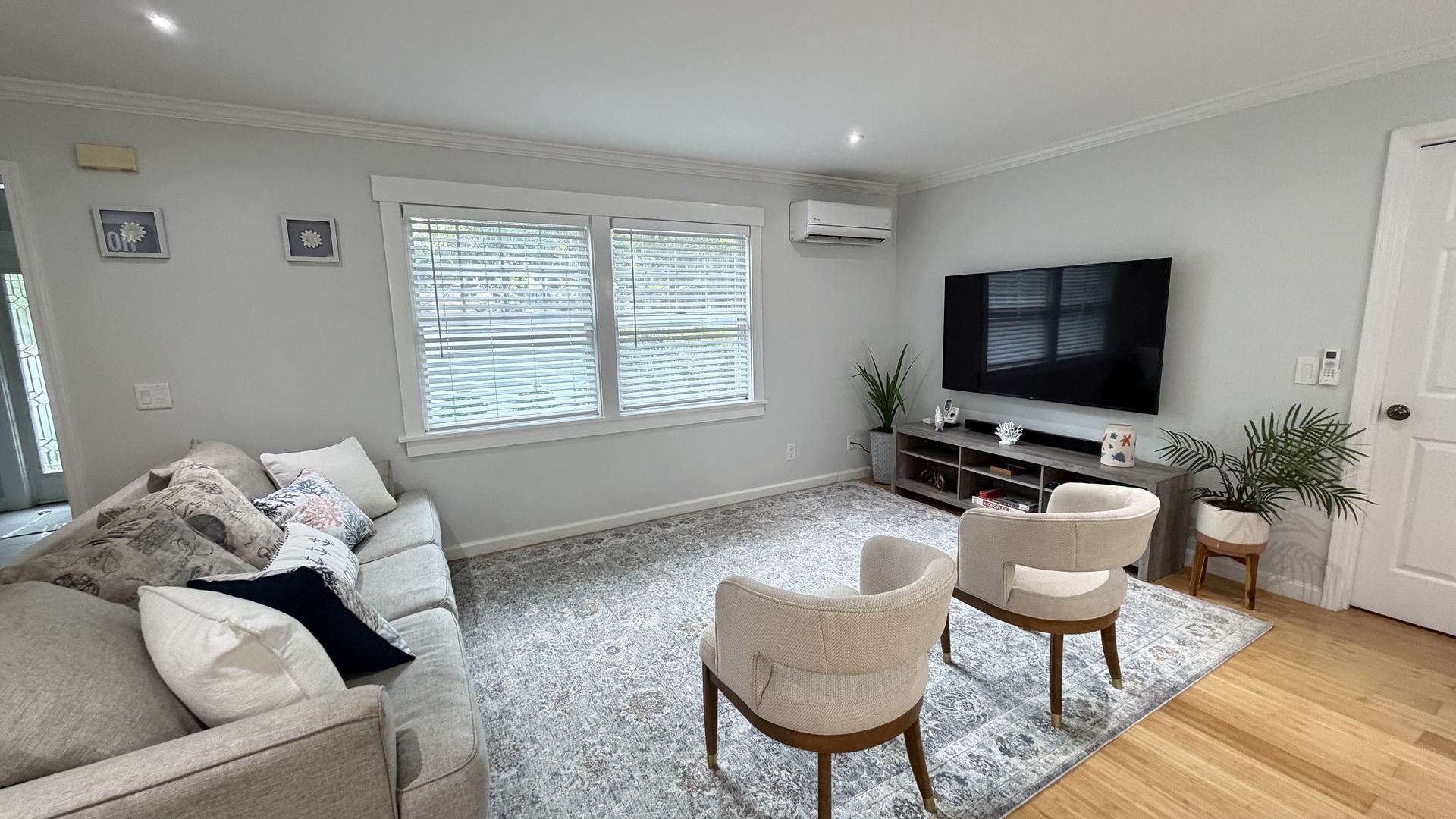 Bright sitting room with smart TV and cozy seating