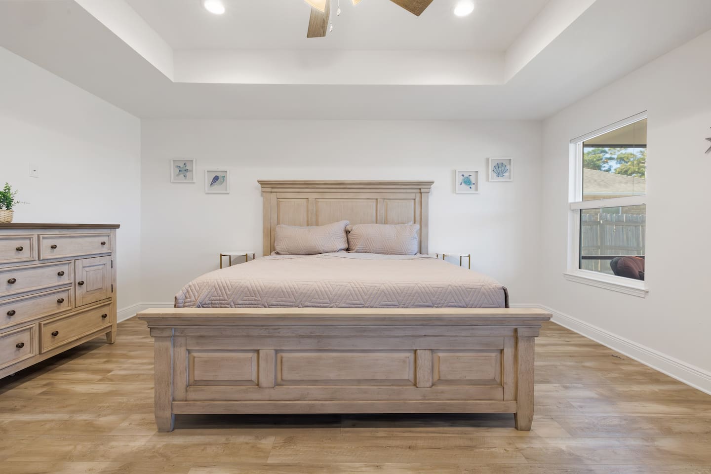This is the master bedroom with a king-size bed.  Look out the window into the backyard and see your kids and pets play.  The master bedroom includes a walk-in shower and a 50-inch Roku TV.  
