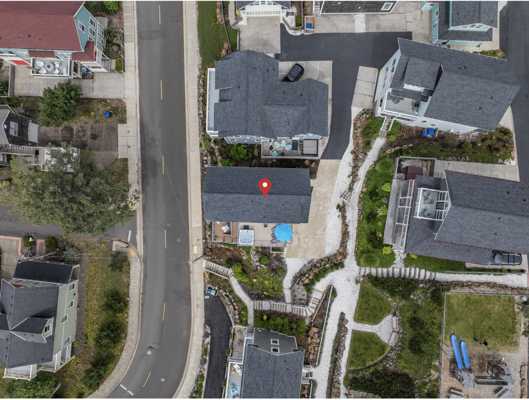 Aerial view showing the driveway, parking area, and home location to make arrival easy.