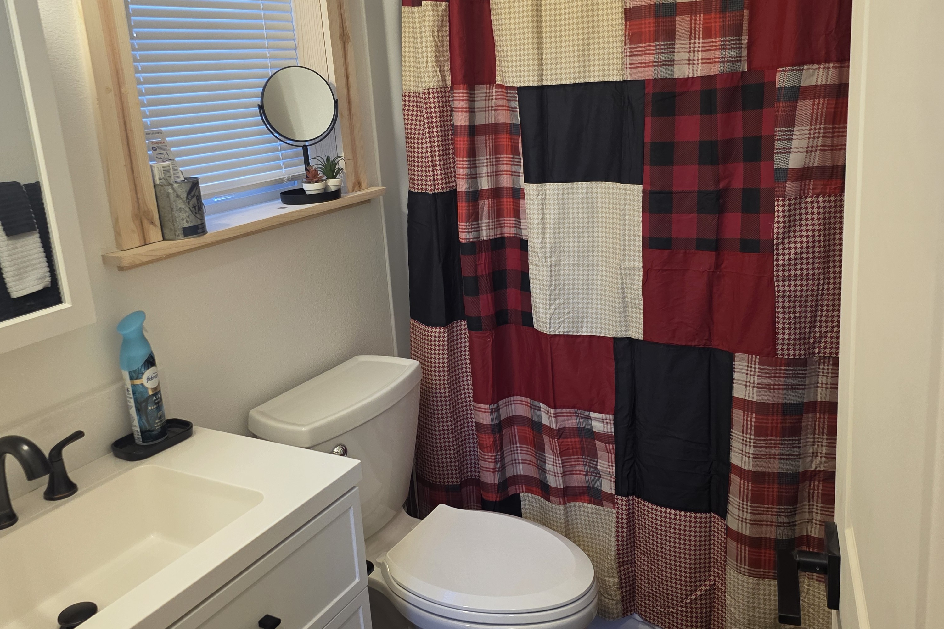 Bathroom includes a vanity, toilet, and shower/tub combo.