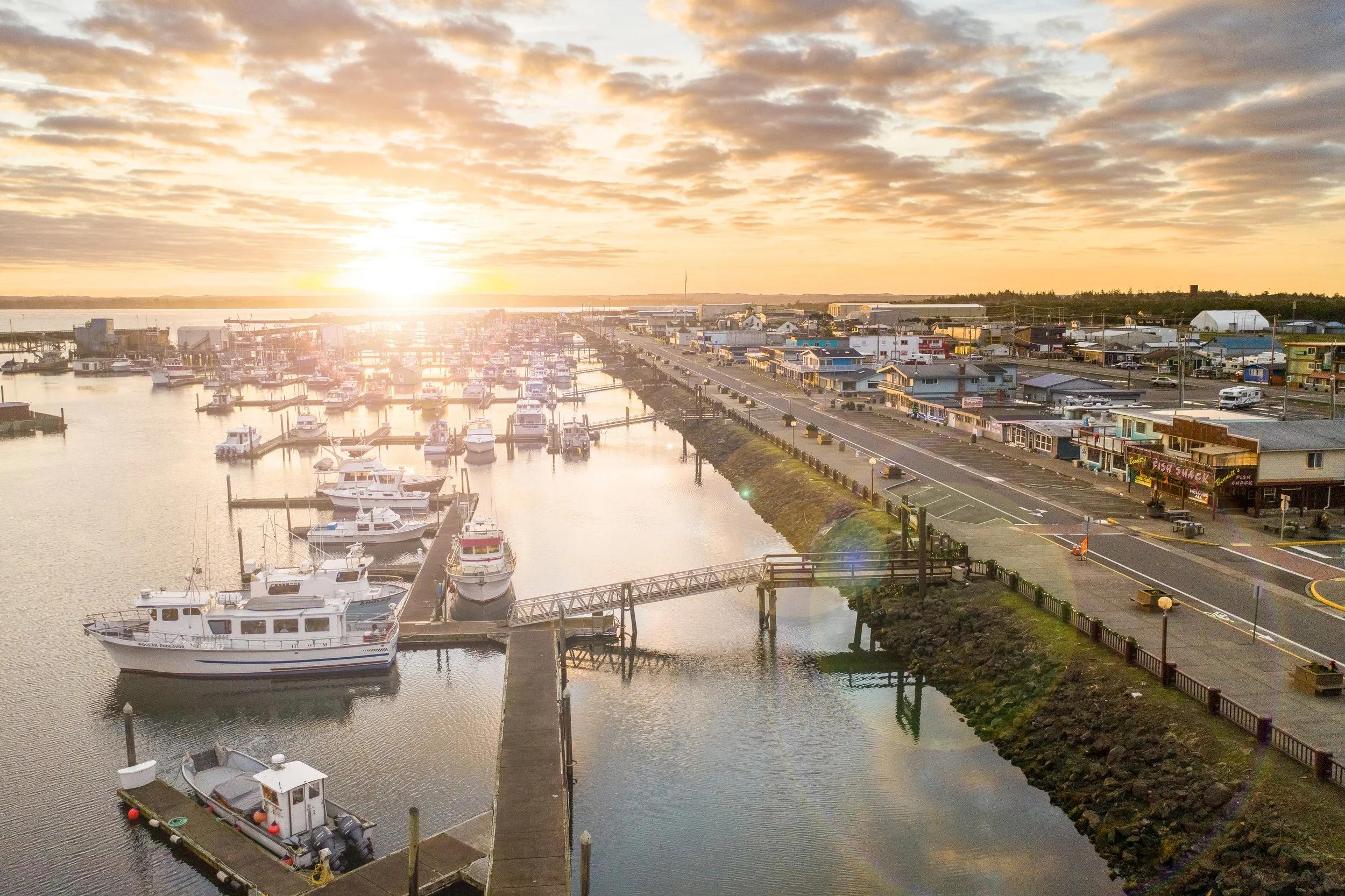 {Harbor Views} Enjoy peaceful evening strolls along the waterfront as boats return to the marina beneath colourful Pacific sunsets.