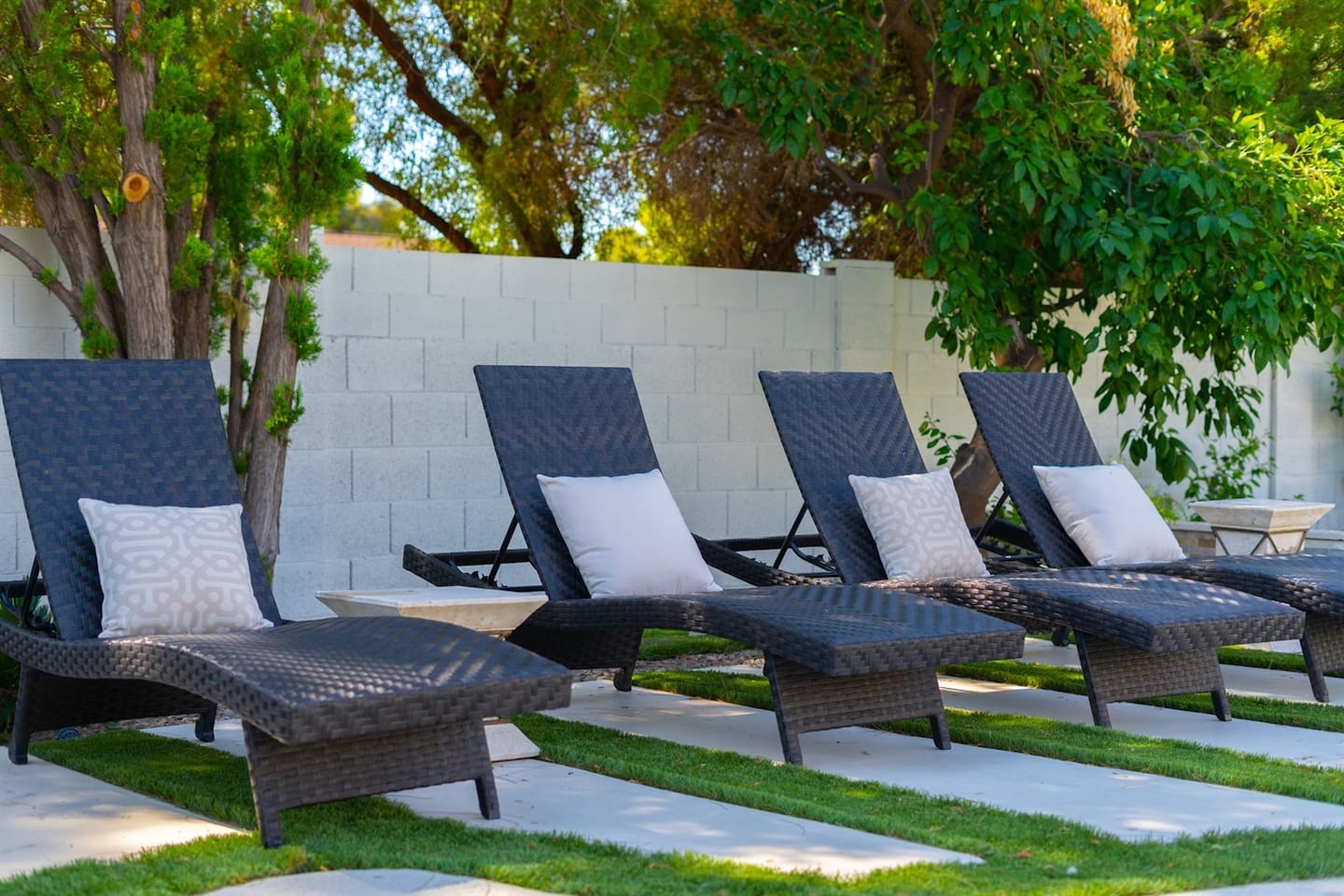Relax by the pool on a comfy lounge chair, surrounded by trees and the soothing breeze. Perfect for unwinding and soaking in the natural beauty!