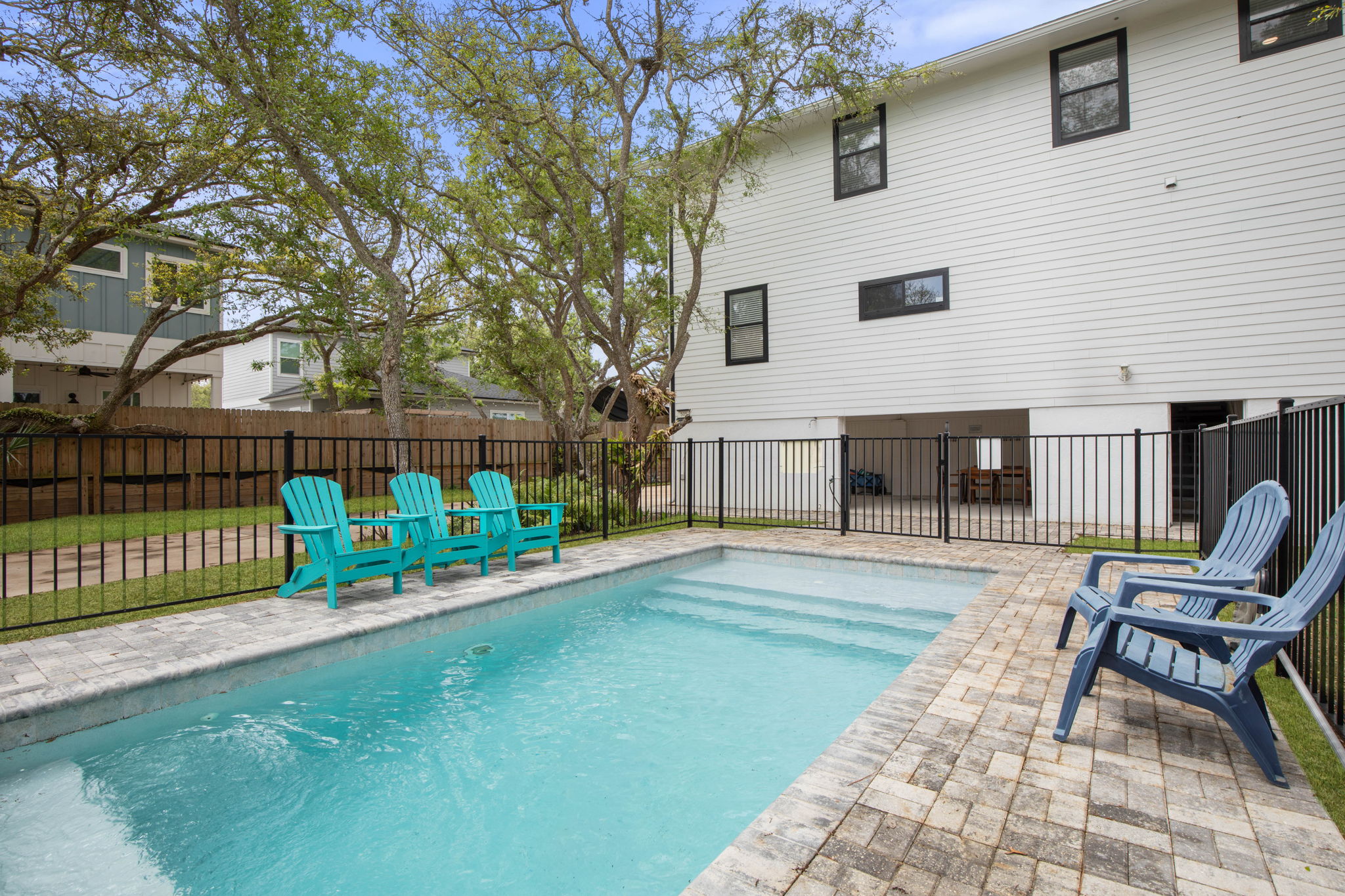 With the pool just steps from the house, the whole family settles into an easy rhythm—kids racing in for one more swim, parents unwinding in the sun, and quiet evenings stretching out under the trees as another favorite vacation memory takes shape.