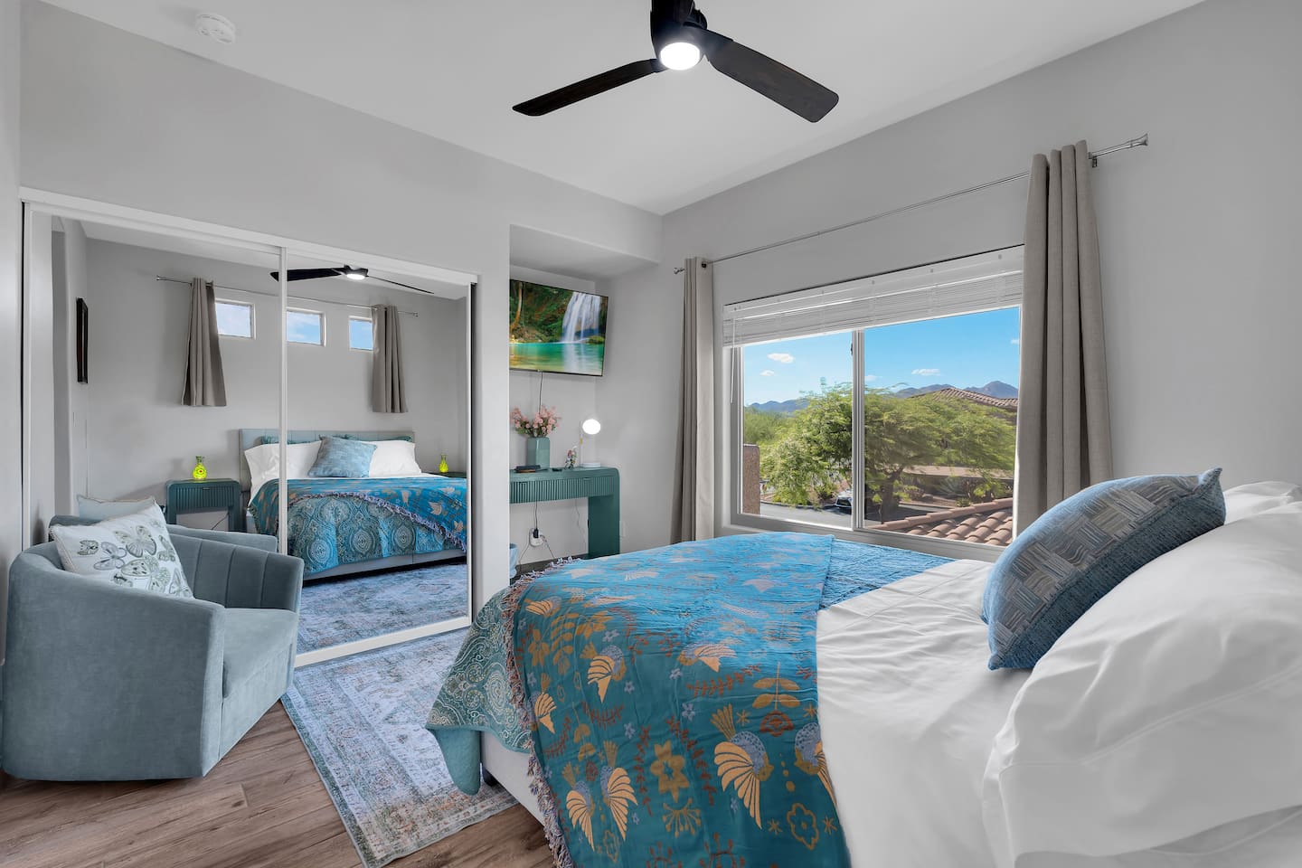 Luxurious queen bedroom with stunning mountain views, smart-TV, and work desk.
