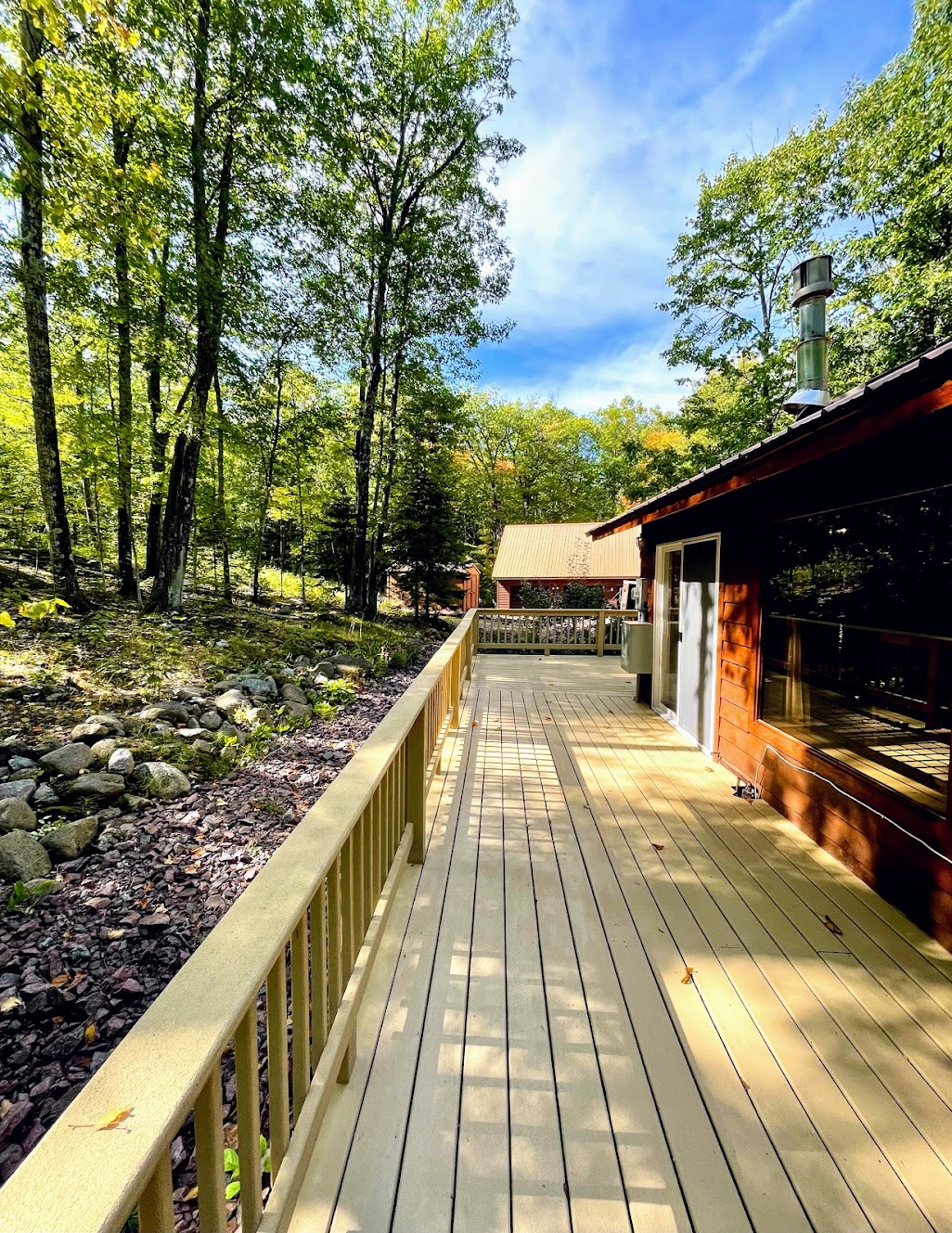side deck looking toward driveway and Rock Garden Cottage other cottage on property 100ft away see listing description for more information still very private 