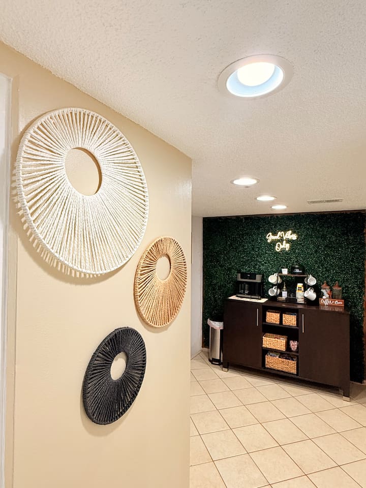 Start your mornings at the fully stocked coffee bar, complete with a stylish greenery backdrop and everything you need for a fresh brew.