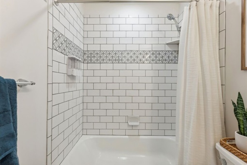 Full bathroom with a tub and shower.