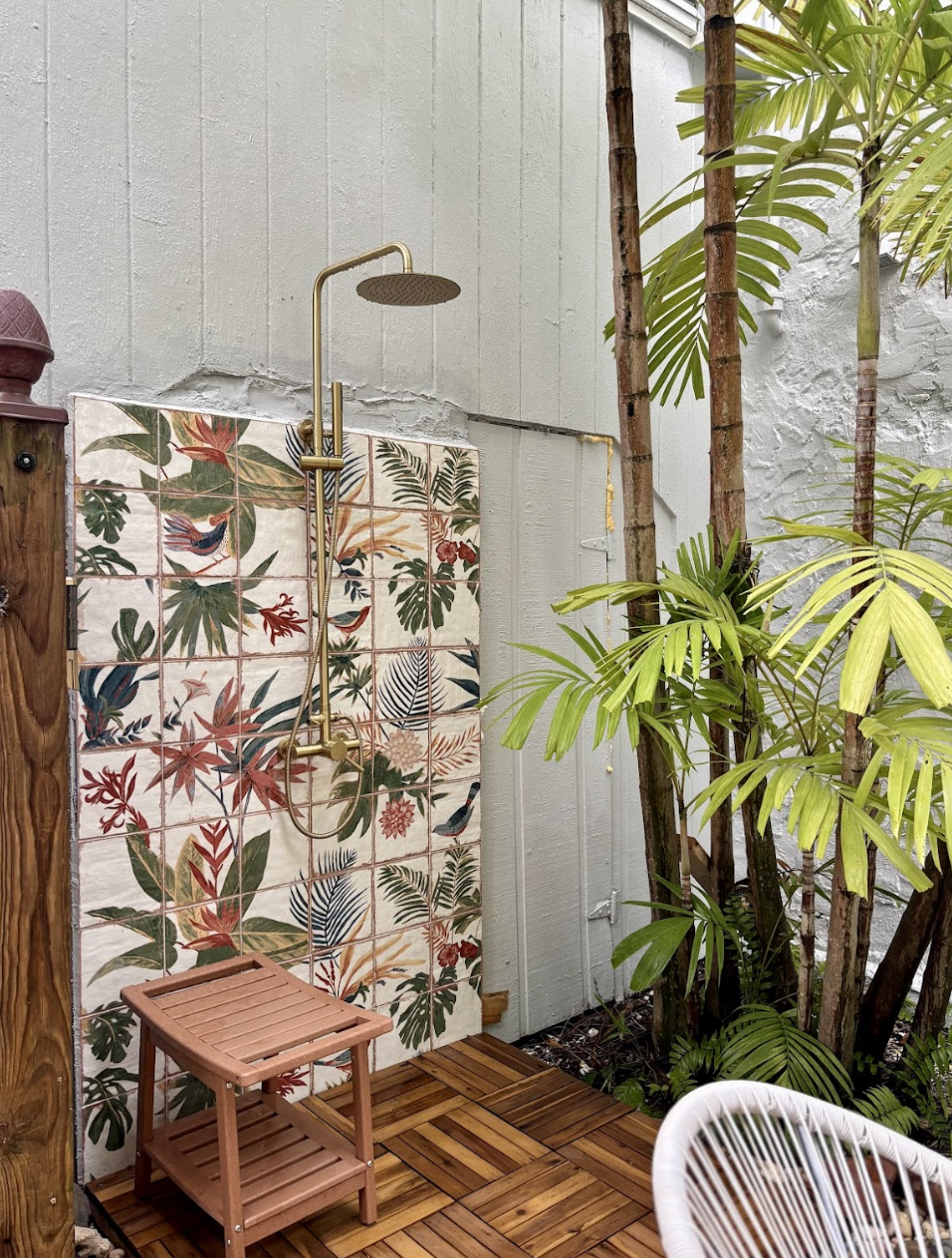 The picturesque outdoor shower has all the tropical vibes.