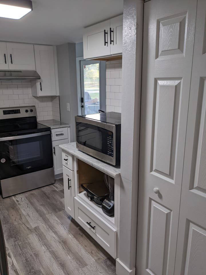 Kitchen connects with living room and dining room.  Complete with kitchen gadgets, microwave and plenty of utensils.