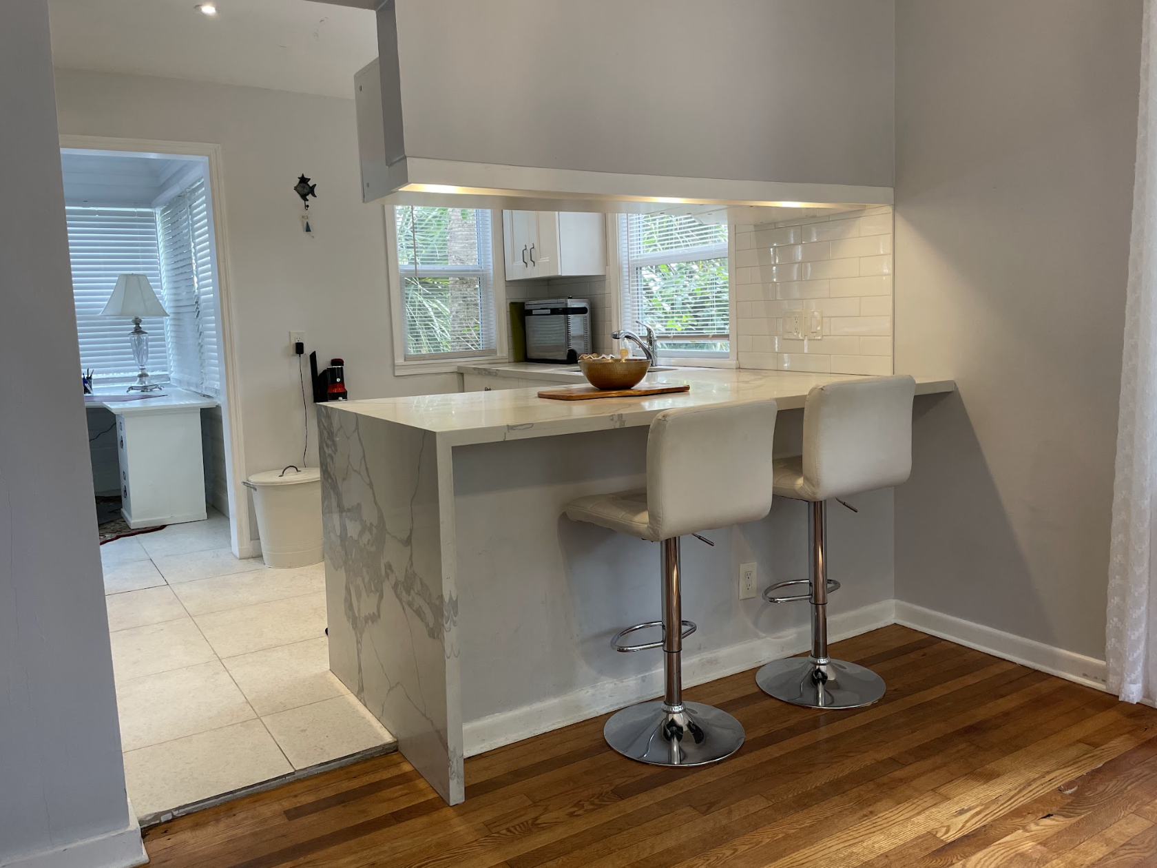Two counter stools sit in the kitchen, a convenient place to enjoy coffee or breakfast.