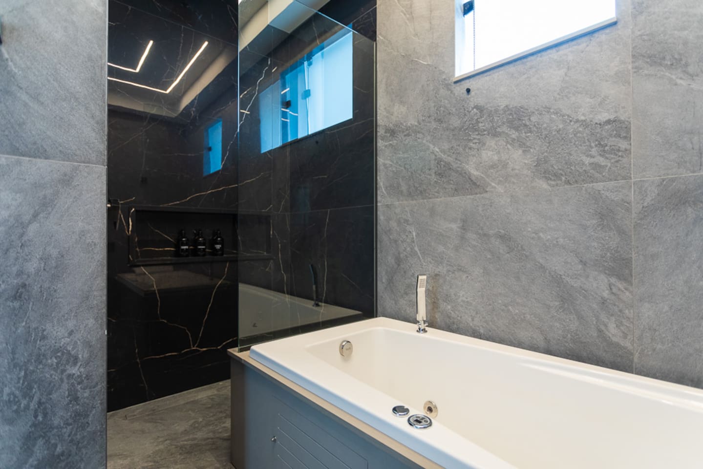 Large walk in rain head shower.   Brand new jacuzzi tub with jets!