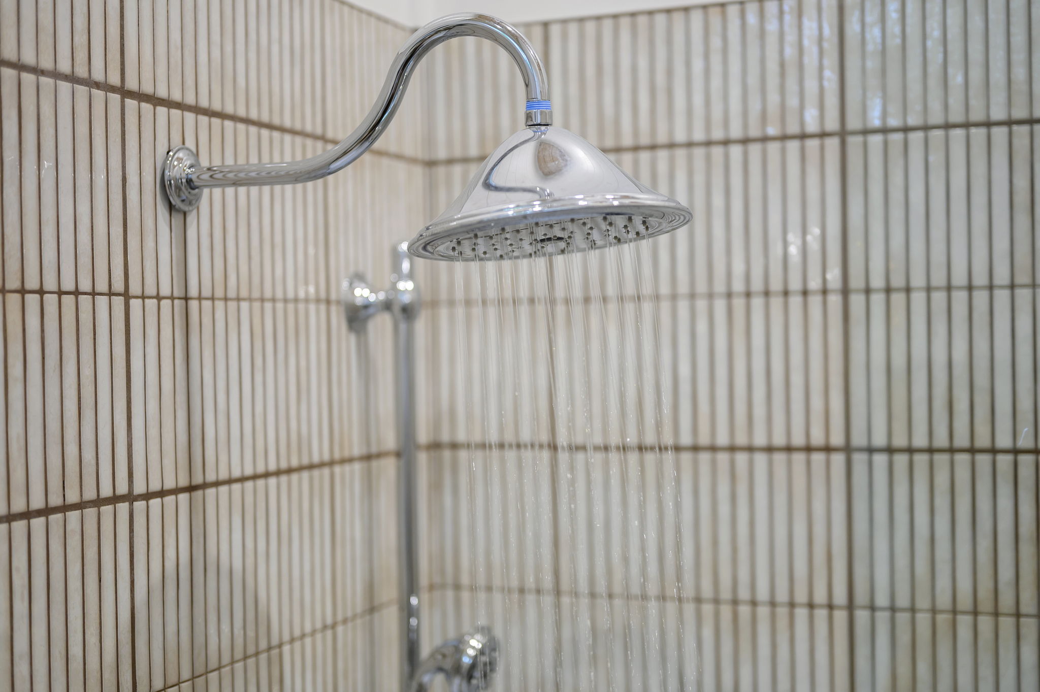 The primary ensuite bathroom offers a warm, spa-like experience with high-end finishes, luxurious touches, and a serene atmosphere designed for comfort and relaxation.