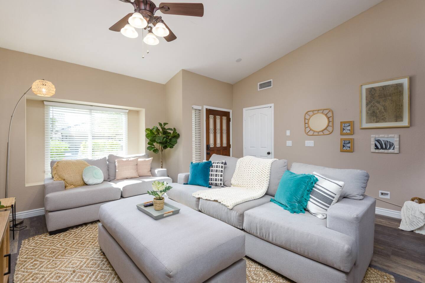 Living room with vaulted ceiling, large Smart TV, comfortable sectional seating, and room to relax or gather indoors.