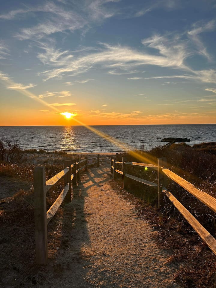 Breathtaking views await! Follow this scenic path directly toward the water to catch a stunning sunset. Whether you're heading out for an evening stroll or just soaking in the glow, this is the coastal escape you've been looking for.