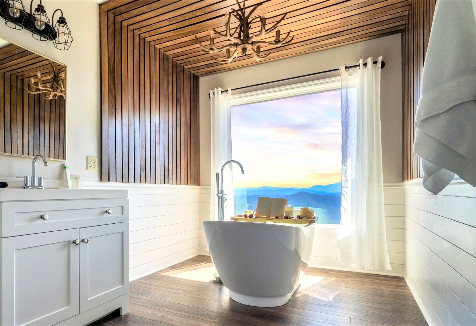 Quite possibly the ONLY cabin in the Smokies that offers a front row seat of THE BREATHTAKING Mountain views from your own freestanding tub. This is an ensuite bathroom from the upper Master.