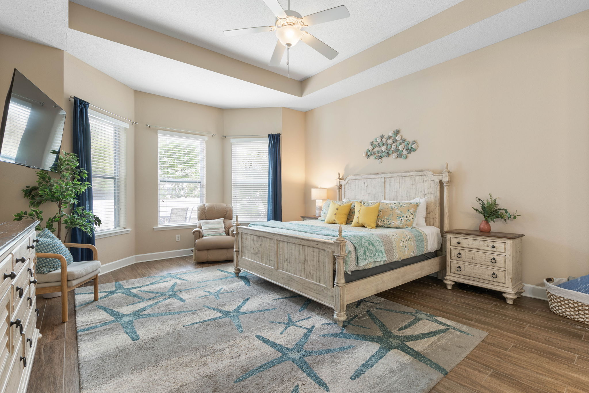 Wake slowly in this serene king retreat, where morning light spills through the windows, a quiet chair invites one more chapter, and the soft coastal palette makes every night feel restful, romantic, and wonderfully removed from the world.