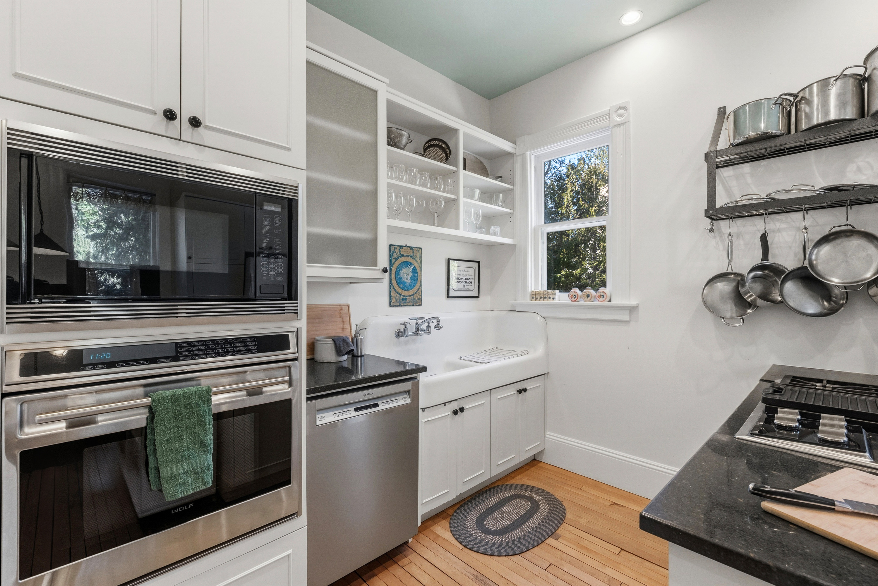 Fully equipped kitchen w/ modern appliances & clean white cabinetry