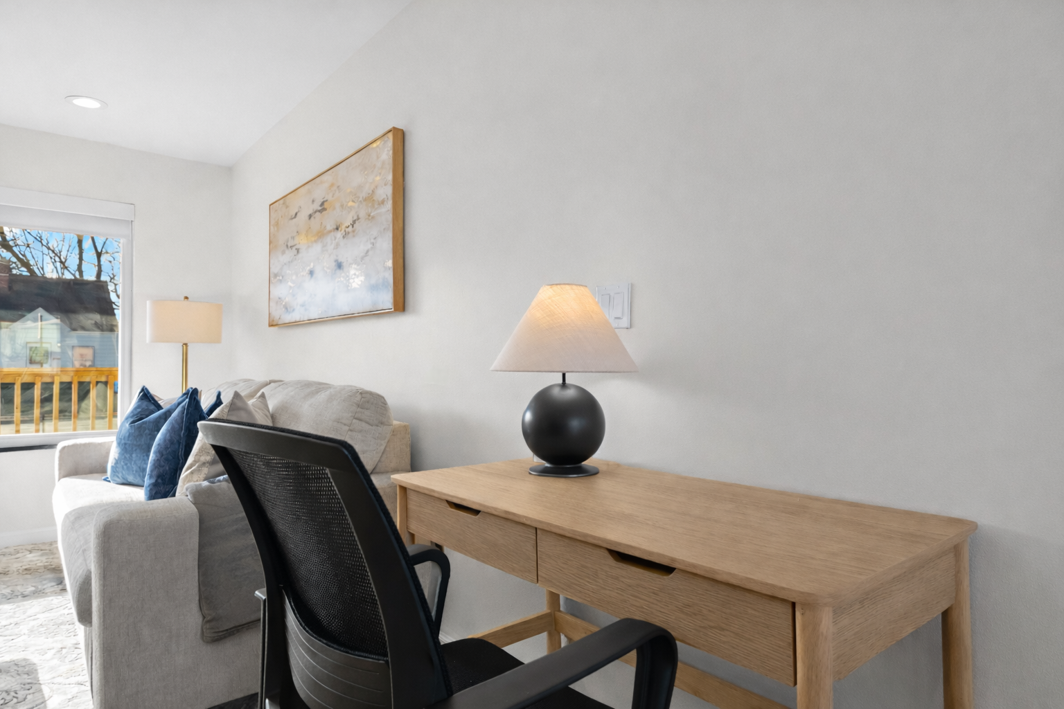 Dedicated workspace with a comfortable desk and chair, natural light, and a quiet setting—perfect for remote work or focused productivity.