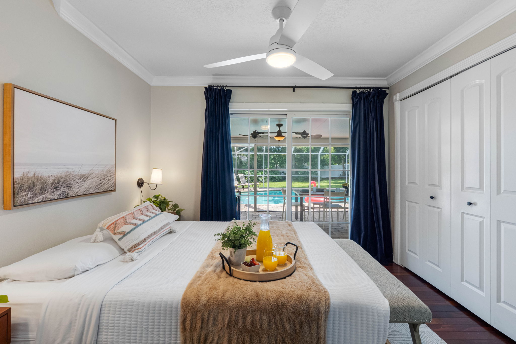Serene bedroom retreat with sliding glass doors opening directly to the poolside patio.