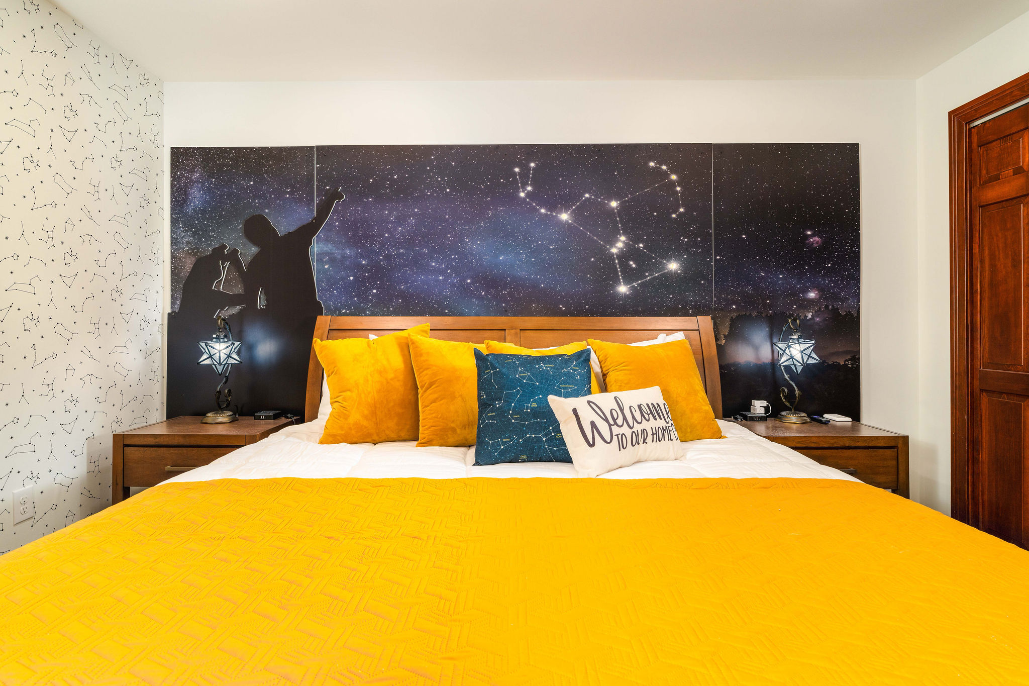 ✨ Constellation Room: king bed under a real night-sky mural, with constellation light-up artwork and star lamps