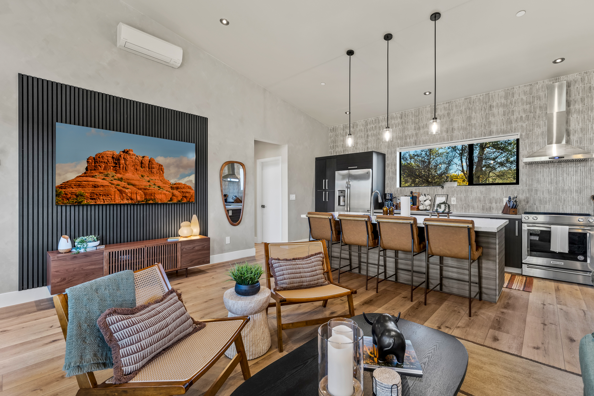 A bright, open-concept living area with comfortable seating, a fully equipped kitchen, and modern finishes - designed for gathering, relaxing, and enjoying time together.