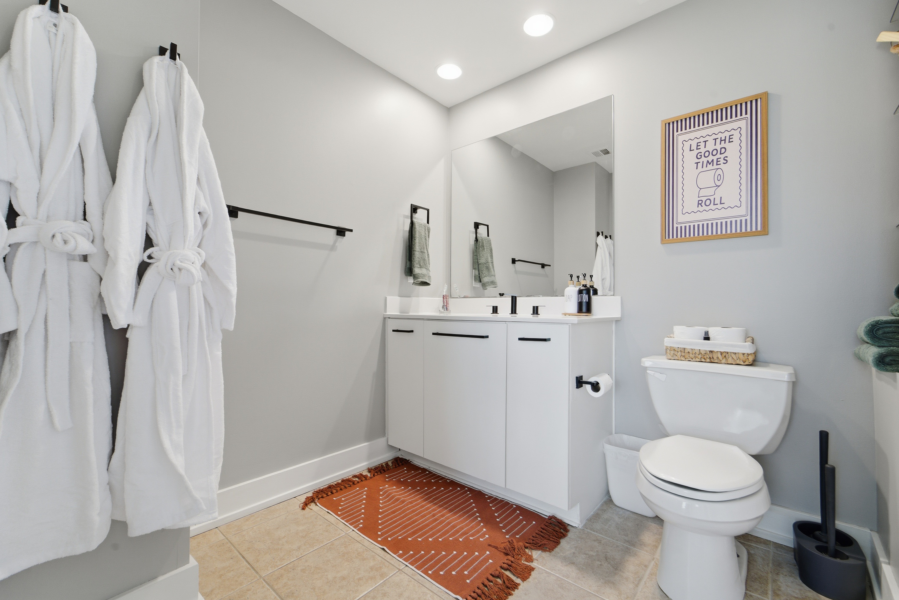 Full bathroom with luxury hotel amenities like: two robes, two pairs of slippers, sauna bucket, eucalyptus oils, make up clothe, travel size toiletries, feminine products, and soft towels.
