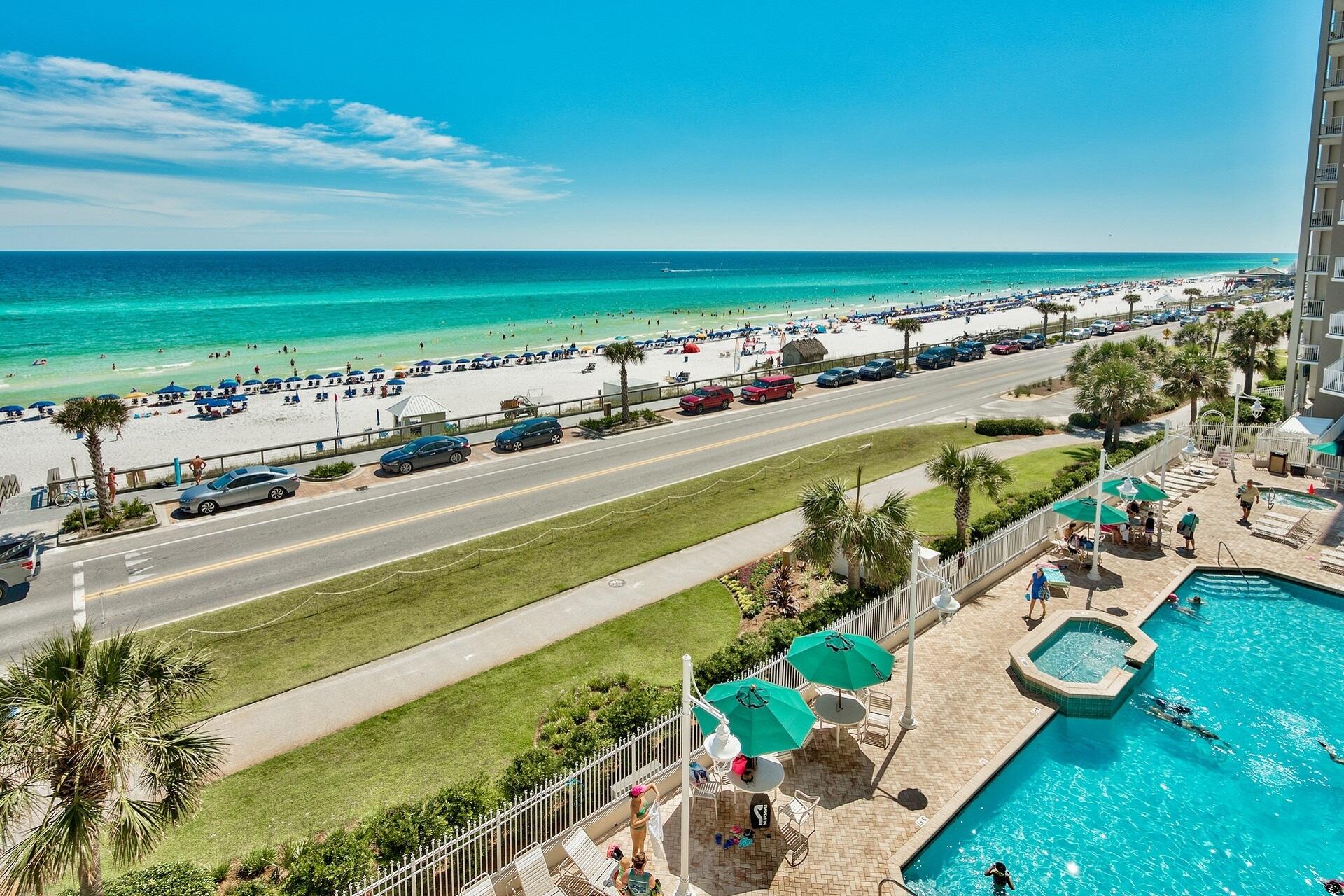 Elevated pool views w/ palm trees & a laid-back resort atmosphere.