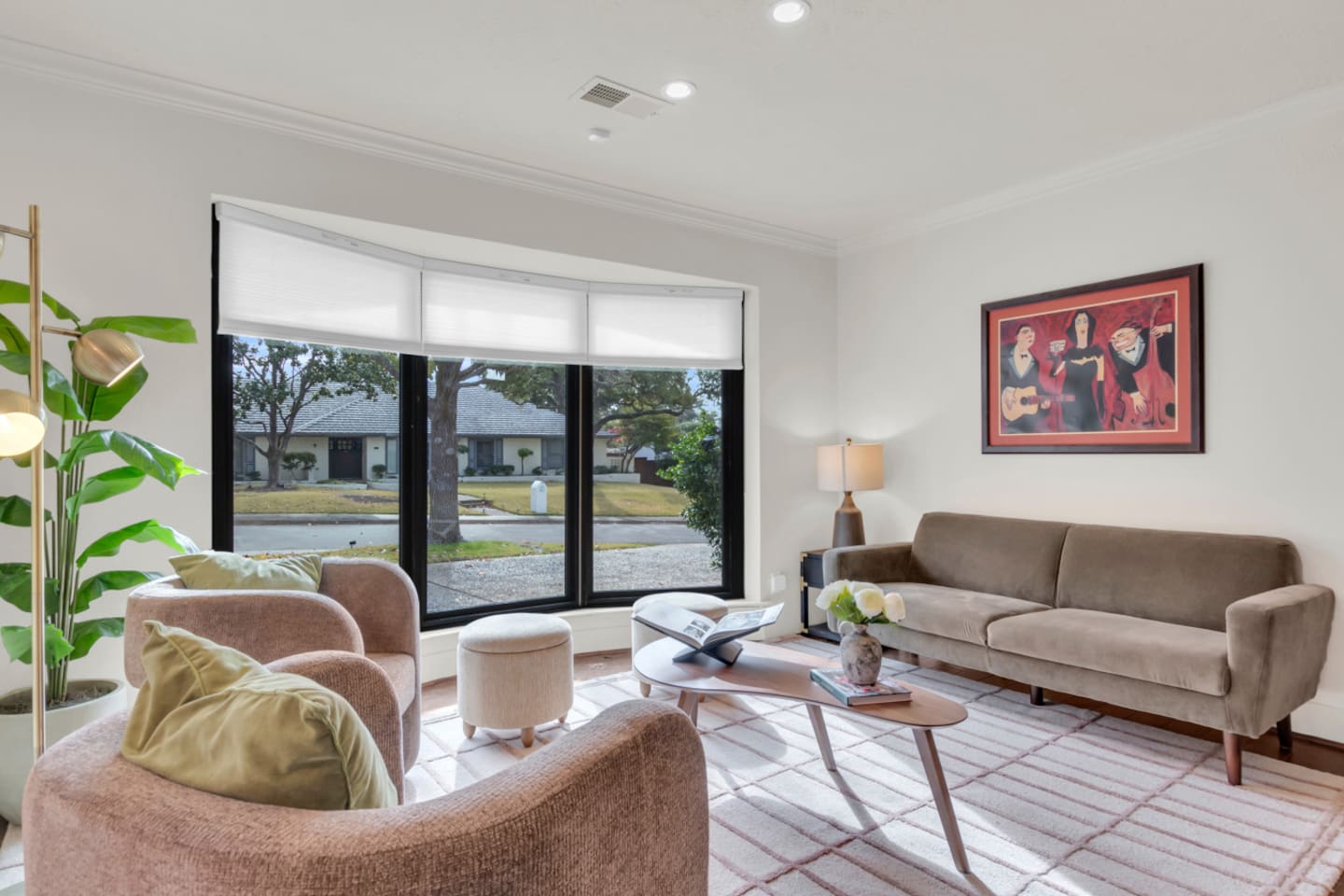 Inviting front sitting area with comfortable chairs and a sofa, offering a relaxing spot to unwind while overlooking the quiet neighborhood.