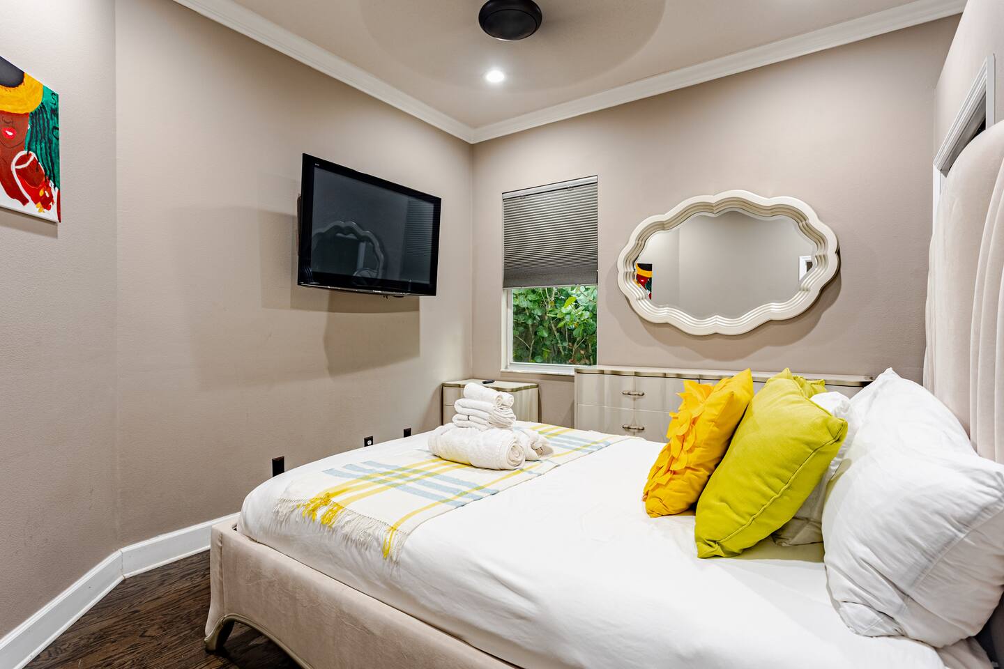 Elegant guest room featuring a plush, comfortable bed, large television, and stylish furnishings, creating a peaceful and inviting retreat for relaxing and unwinding after a day of adventure.
