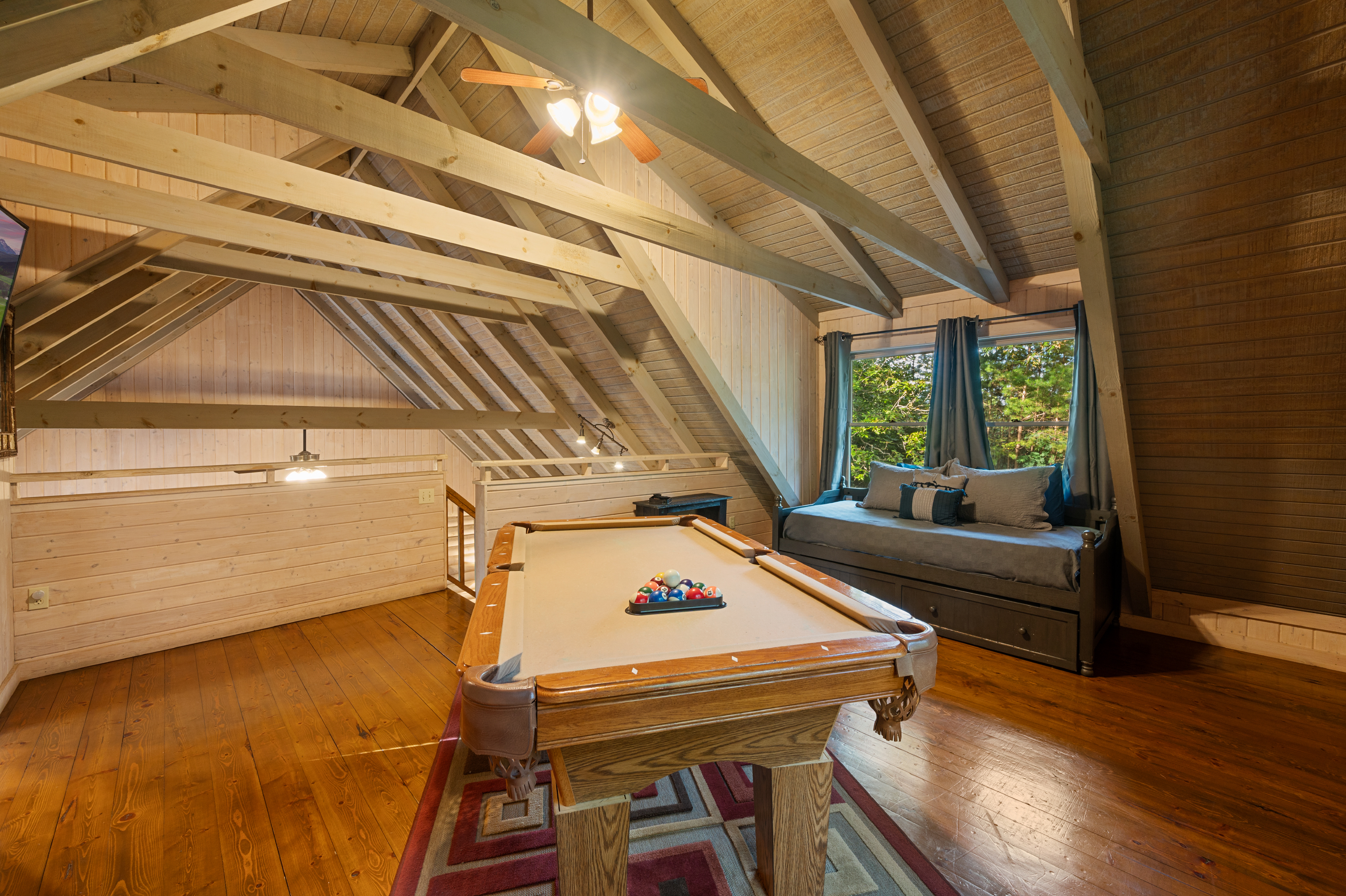Your mountain retreat loft: Enjoy games on the pool table & relax on the trundle bed.