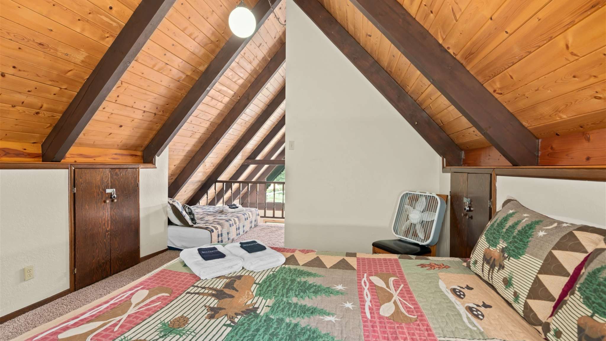Loft bedroom with queen beds and bright natural light.
