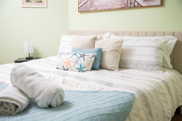 Spacious, cozy bedroom with a fireplace. Stretch out in the queen-sized bed while your little sleeps soundly in the crib.