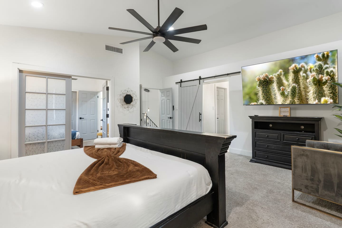Spacious bedroom with smart TV and entertainment space.