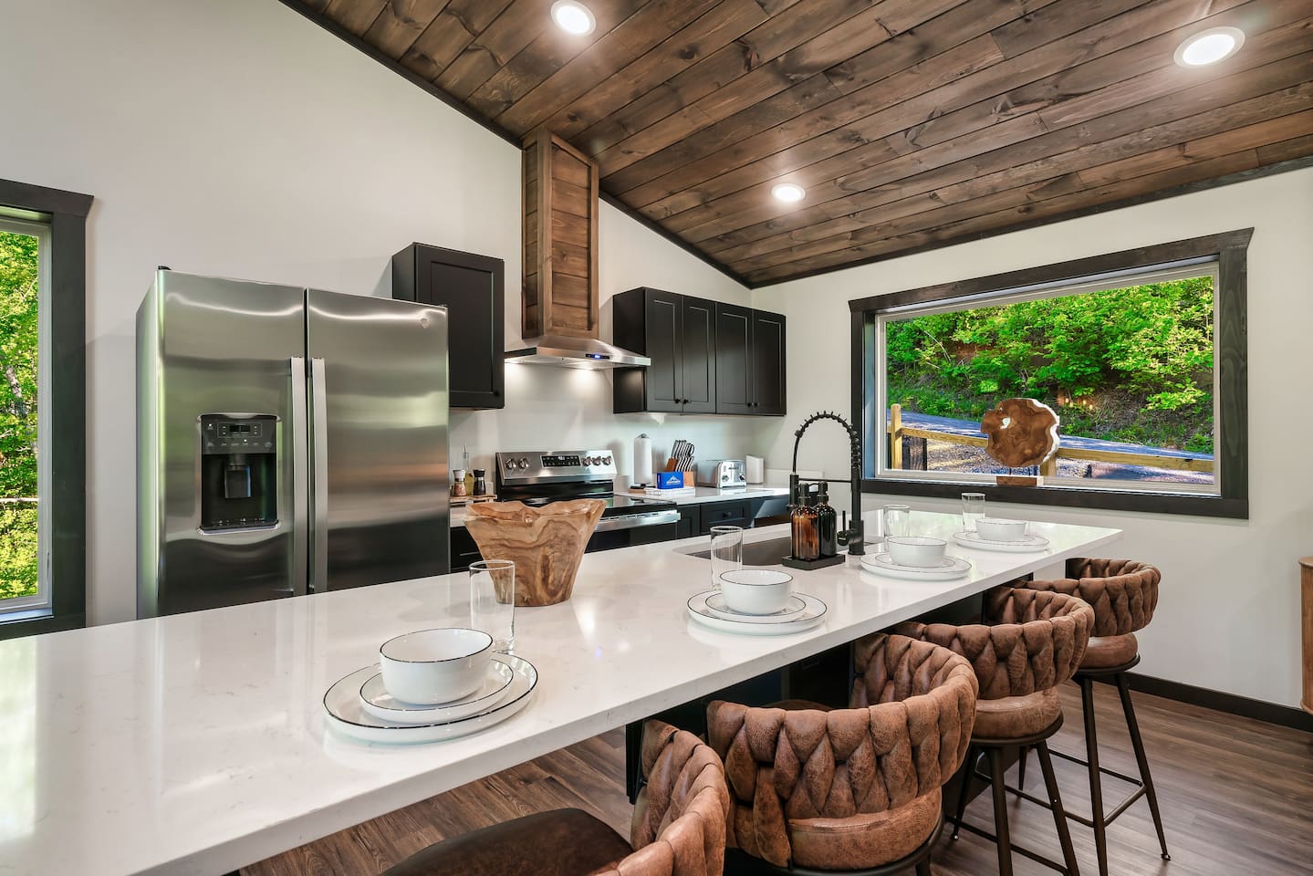 Fully equipped modern kitchen with large island and seating for four.