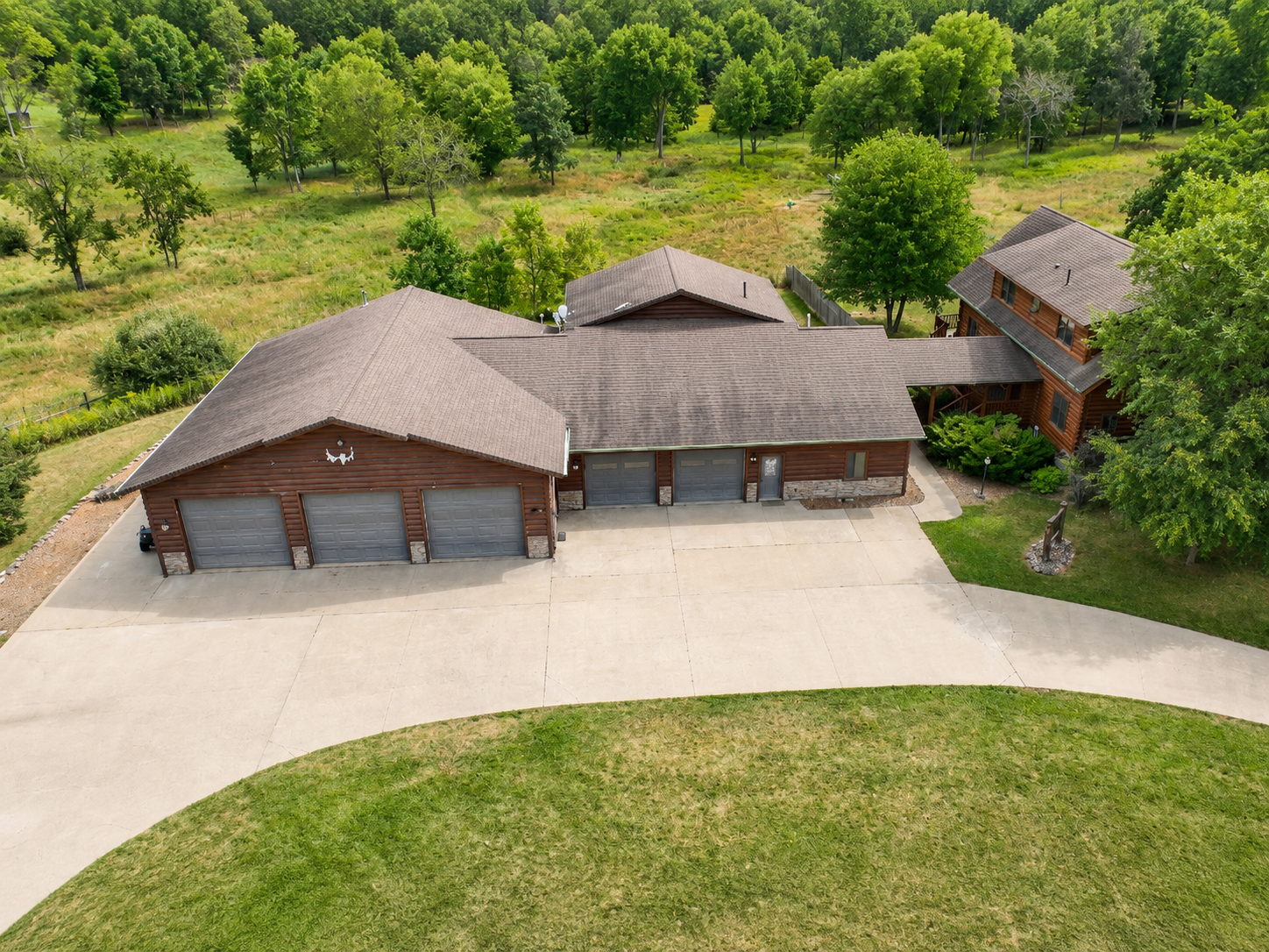 Aerial view shows the House, neighboring Lodge and shared parking areas so guests can clearly understand the property layout.
