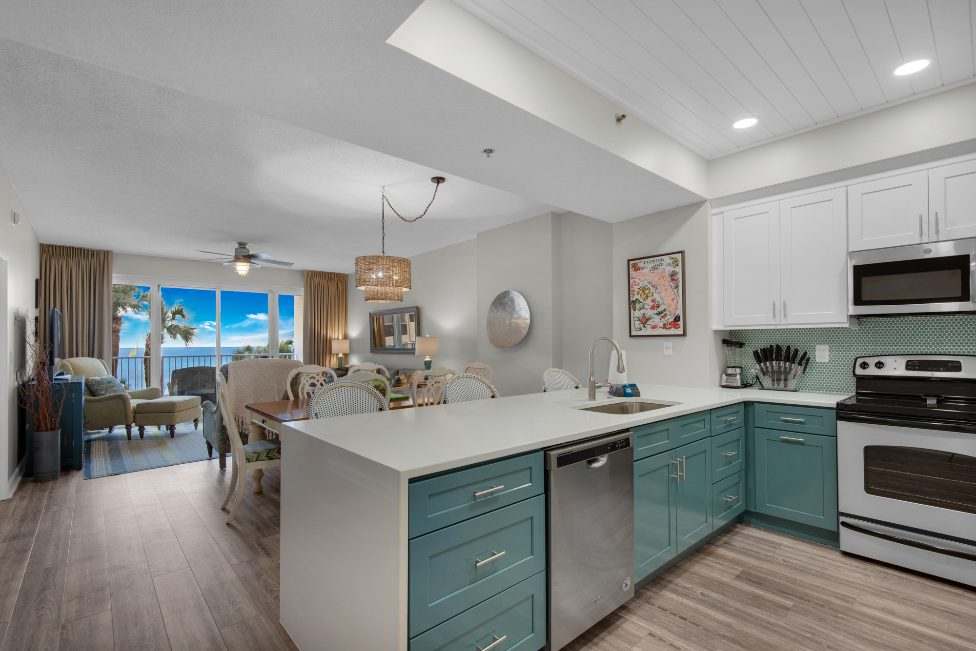Open kitchen and living area with Gulf views and a TV. Living-room furniture shown has since been replaced.