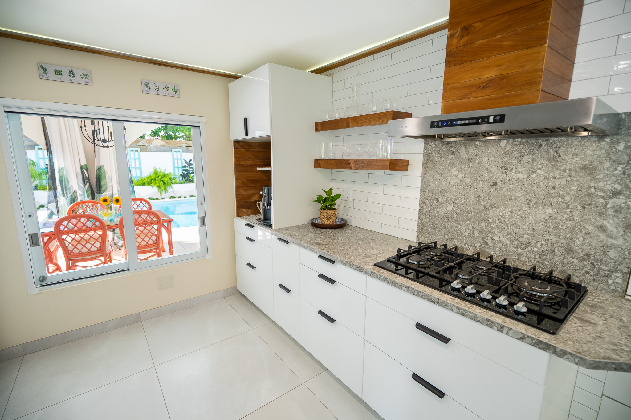 This view showcases our stove top with the coffee and tea bar and pool in the distance in Dorado, Puerto Rico.