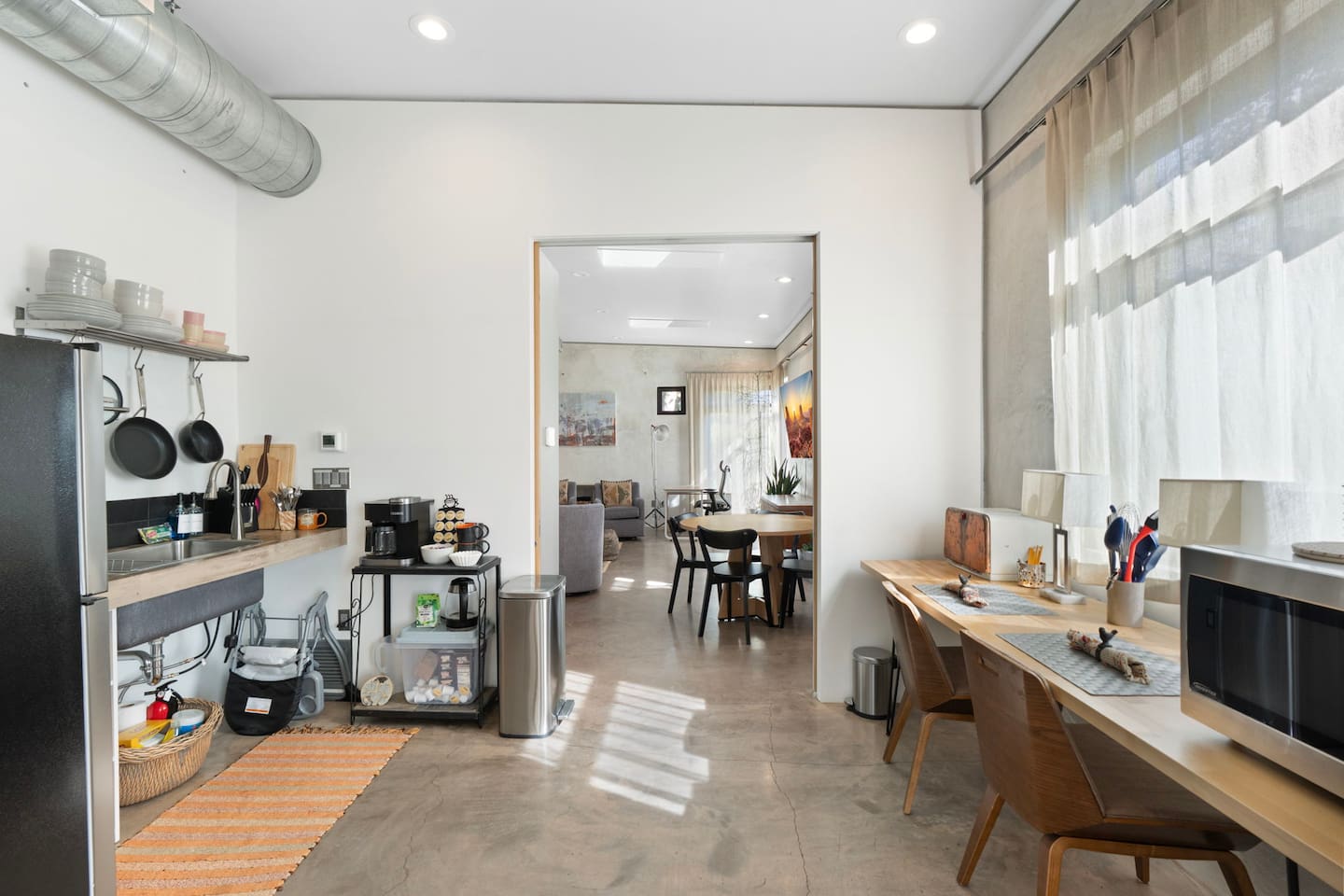 Bright kitchenette and workspace area with modern finishes and an open flow into the living space.