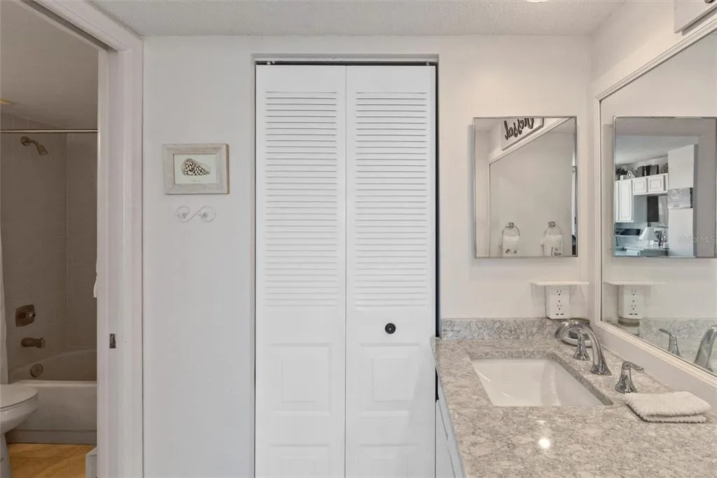 The en-suite master bathroom features a spacious, clean layout with modern finishes, fresh towels, and thoughtful details designed for comfort and convenience.