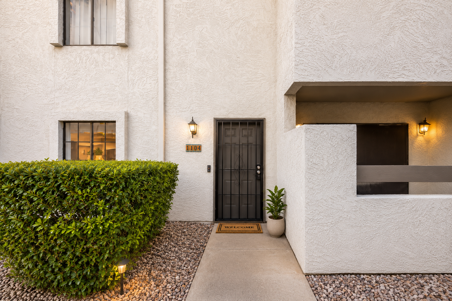 Front entry with a short walkway, covered patio area, and easy access to the unit.
