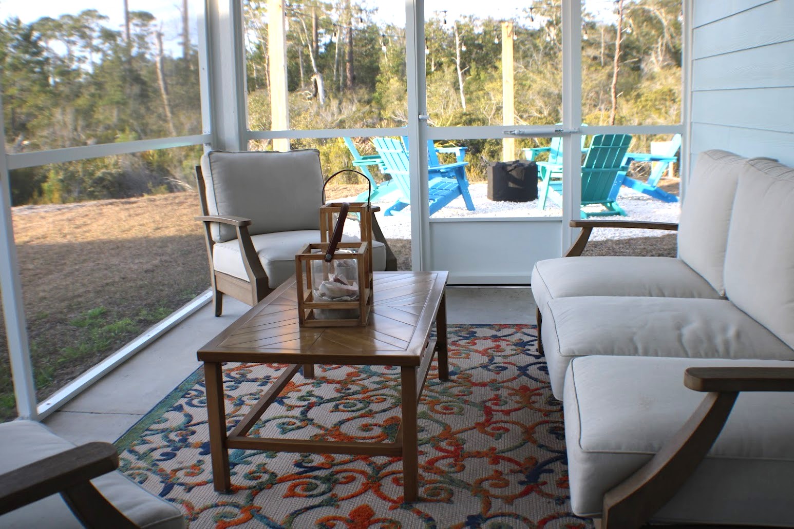 Screened-in back porch with outdoor seating—enjoy evenings bug-free.