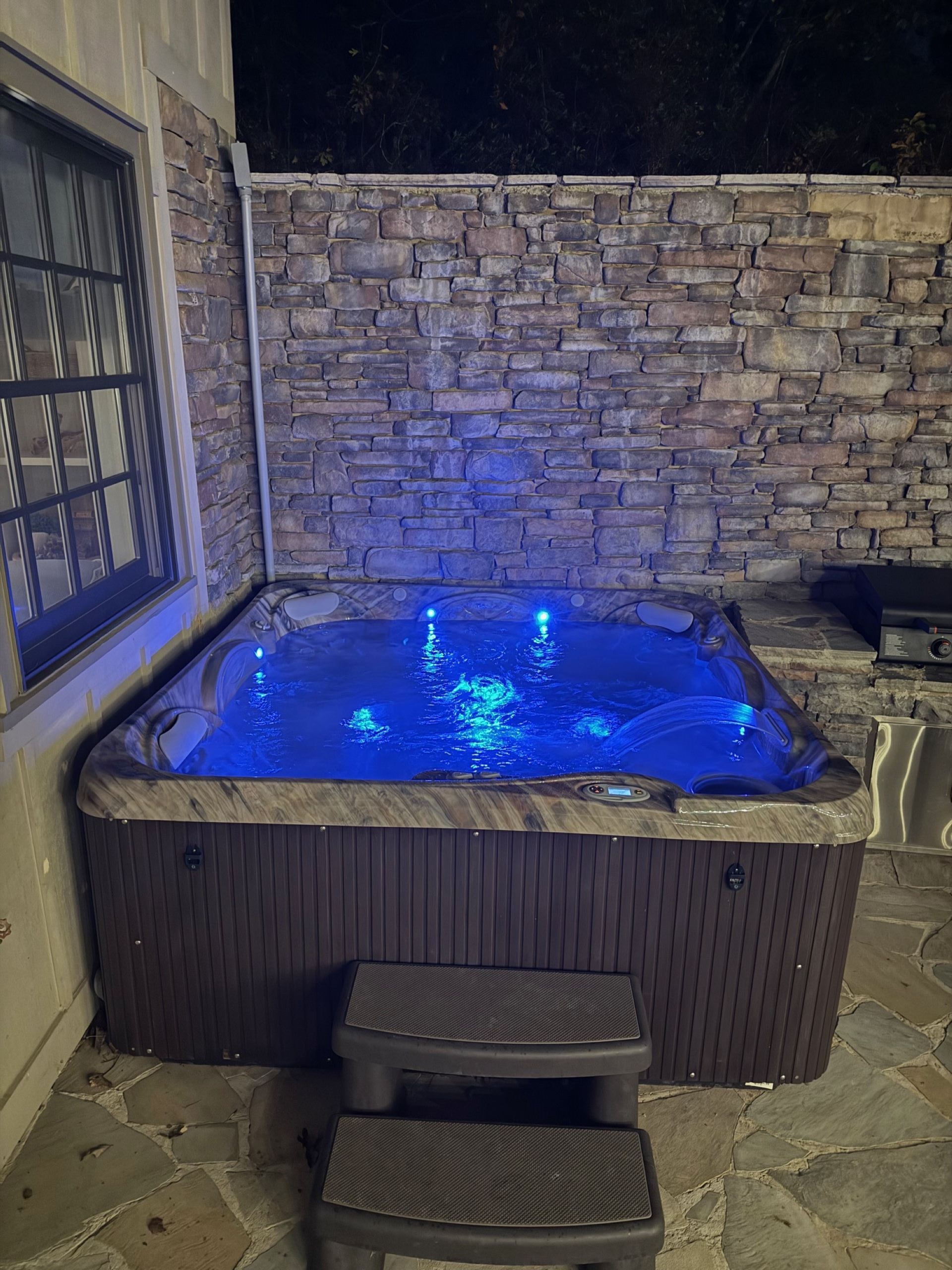 Relax in the hot tub at night, surrounded by soft lighting and peaceful lake views—the perfect way to unwind under the stars.